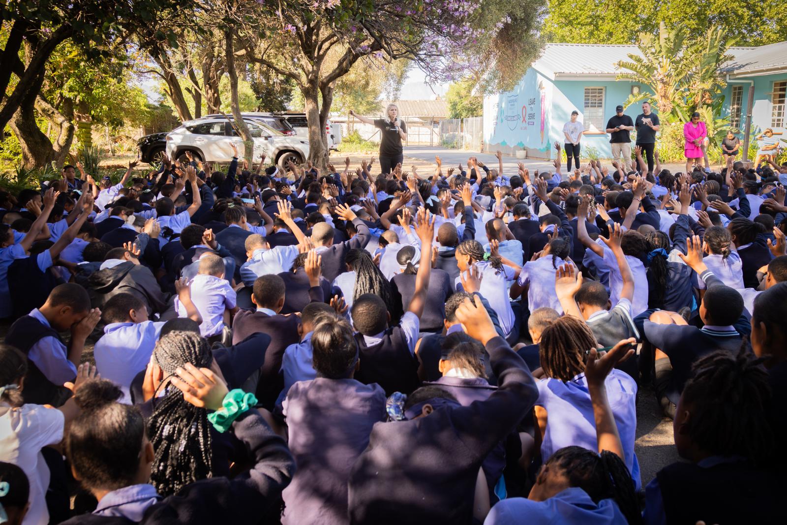 Students receiving ministry with raised hands
